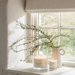 Windowsill in the Unique Homestays x The White Company Fable property, with plant and candle
