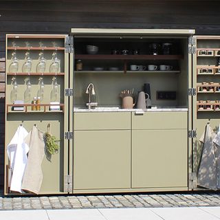 outdoor kitchen with cupboard and dishwasher