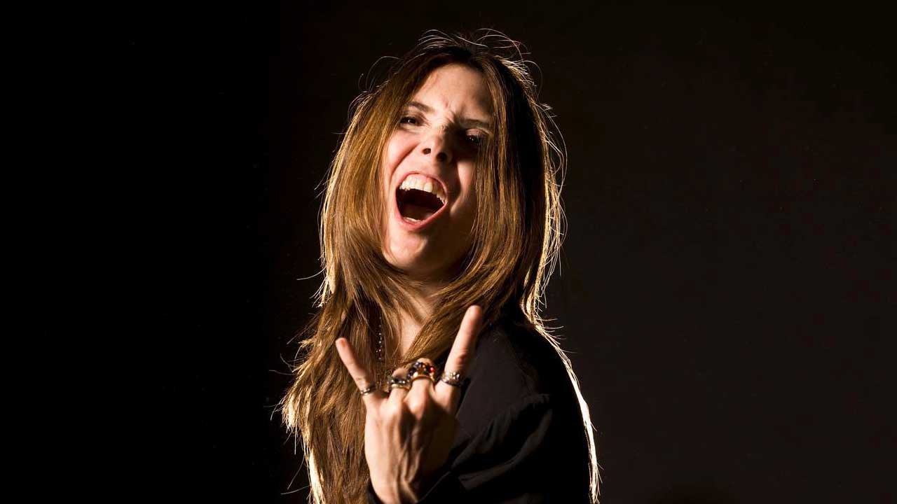 Fiona throwing the horns (studio portrait)