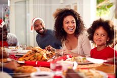 Happy family laughing over Christmas dinner table