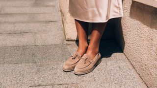 woman wearing smart suede loafers