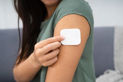 HRT shortage UK 2022: A woman using a HRT patch