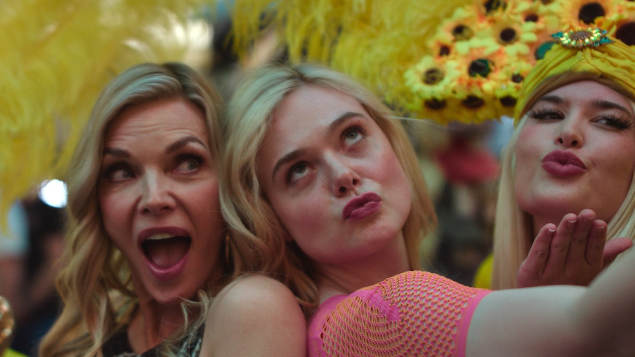 Michelle Pfieffer and Elle Fanning posing with dancers in Las Vegas in Margo's Got Money Troubles Season 1, episode 5 