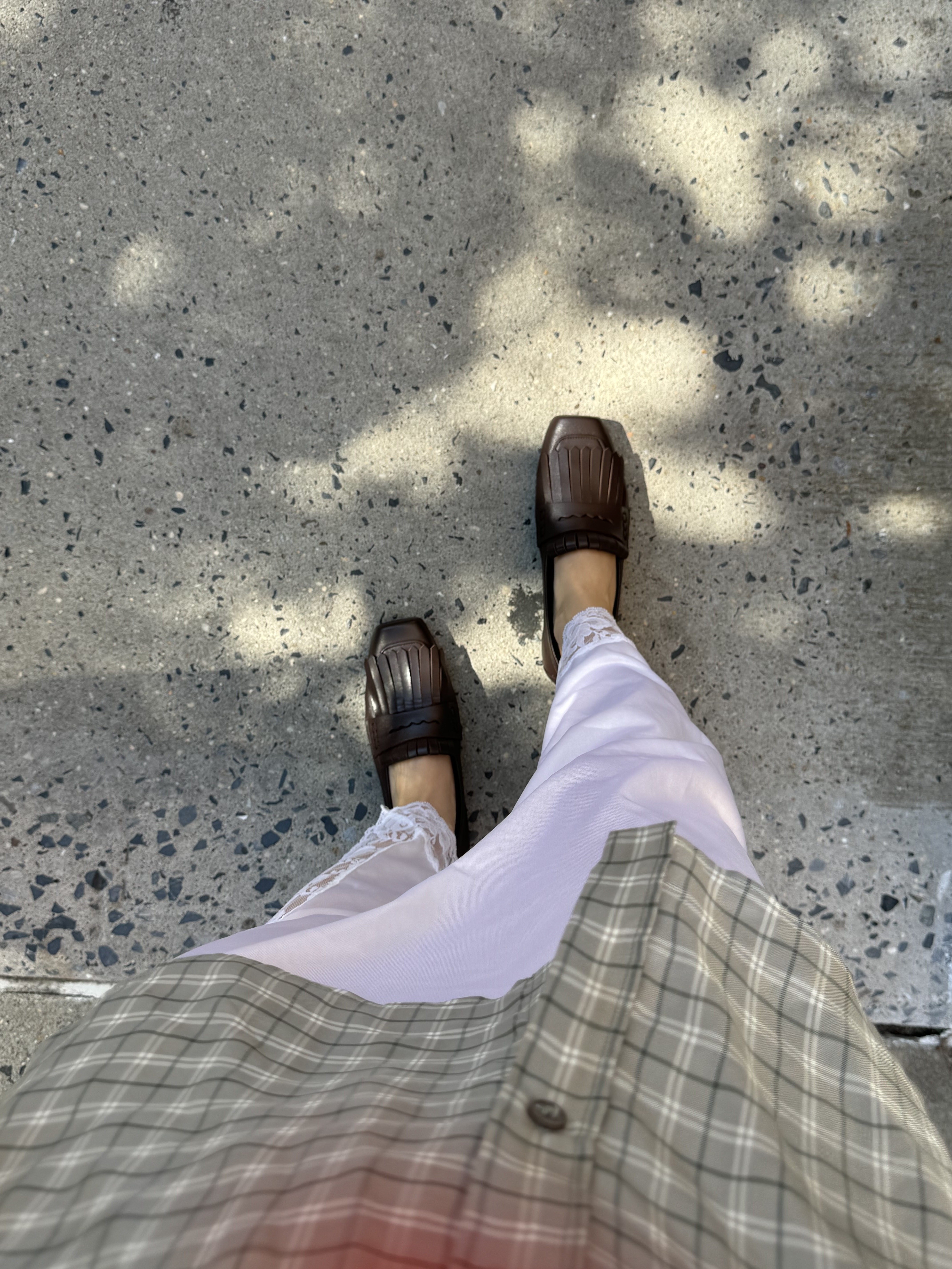 Brown leather tassel loafers, white lace skirt, blaid button-down