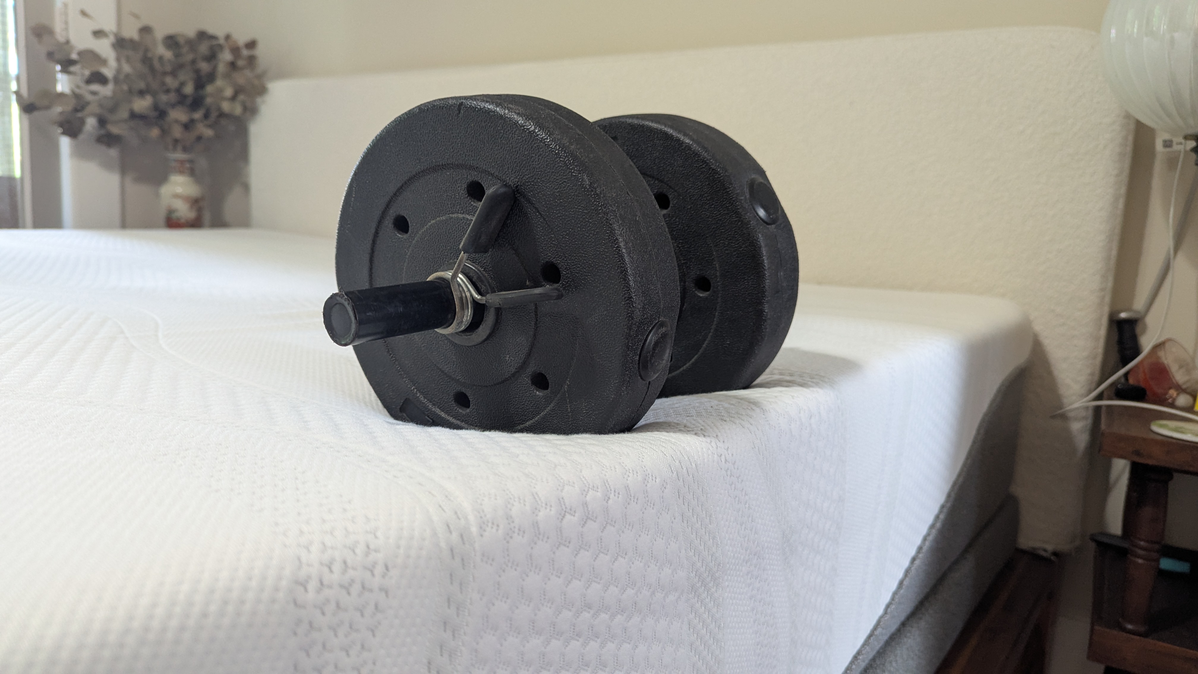 Dumbbell placed on edge of Sleep Number i8 smart mattress