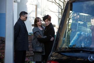 Sonia Fowler comforts Dot Cotton outside a hearse as Fatboy watches on