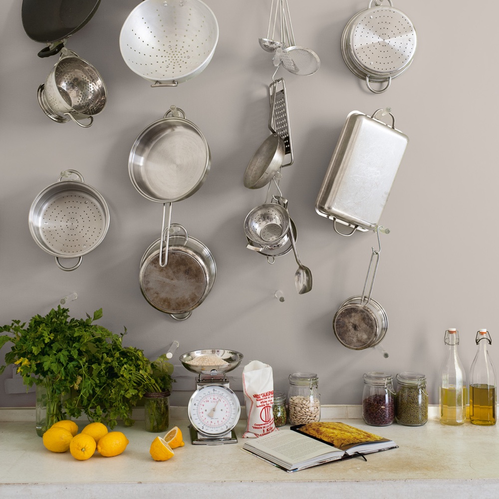 kitchen area with grey wall and kitchenware