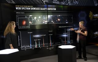 two people on stage explain a diagram of a telescope observation