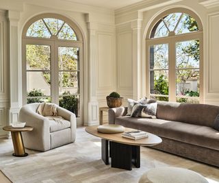 seating area with brown sofa and arched windows