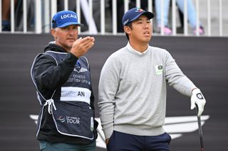 An talks with his caddie during the Scottish Open