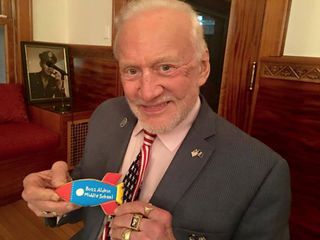 Apollo 11 astronaut Buzz Aldrin displays a cookie decorated to mark the renaming of Mount Hebron Middle School in Montclair, New Jersey as Buzz Aldrin Middle School.