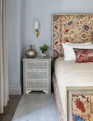 a bedroom with south east asian style textiles