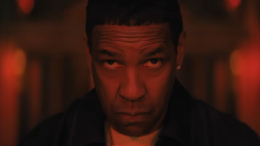 Screengrab from the "Highest 2 Lowest" official teaser featuring a shot (lit in red) of Denzel Washington's face in close up