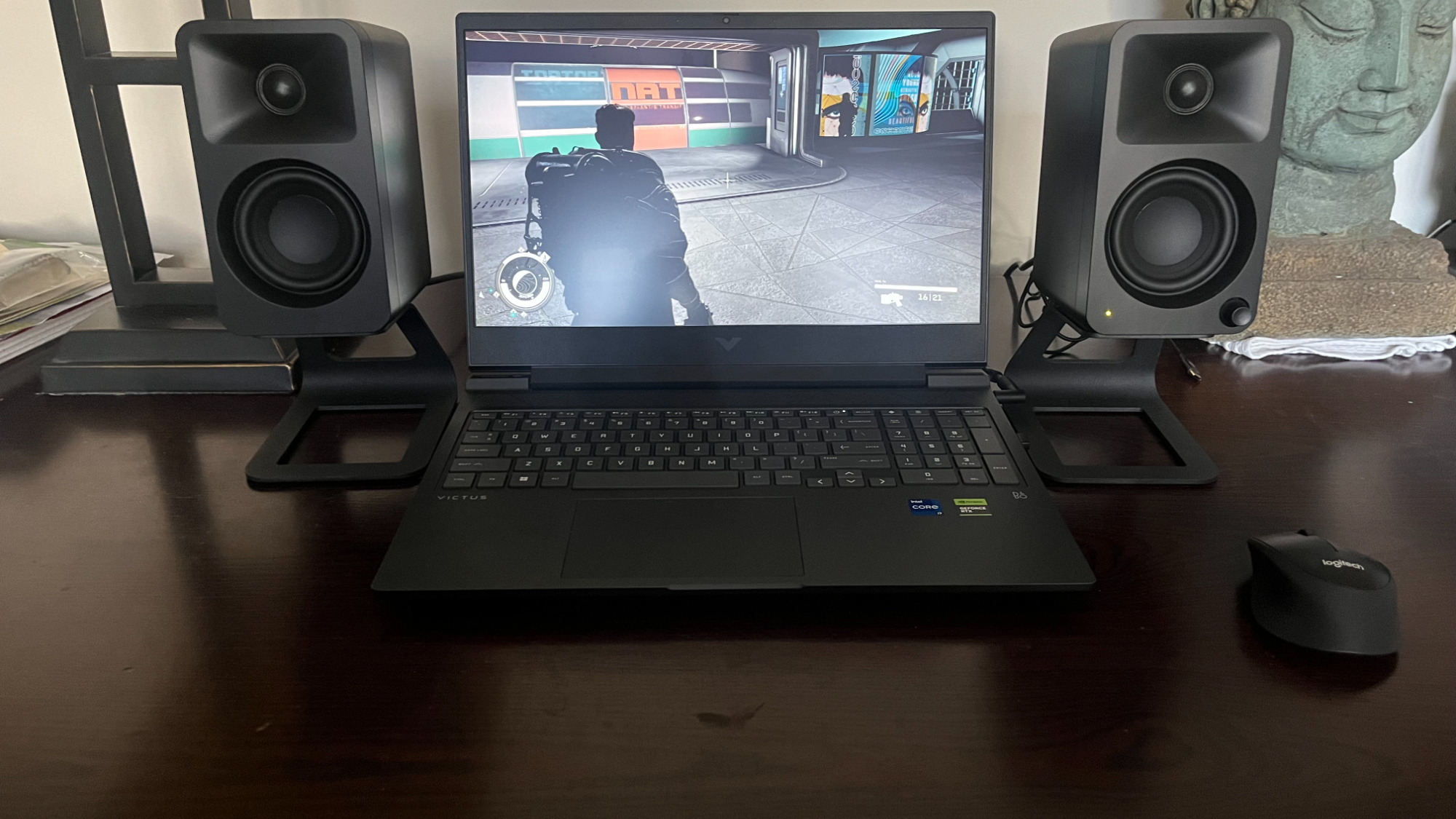 HP Victus 16 gaming laptop on a desk playing a game