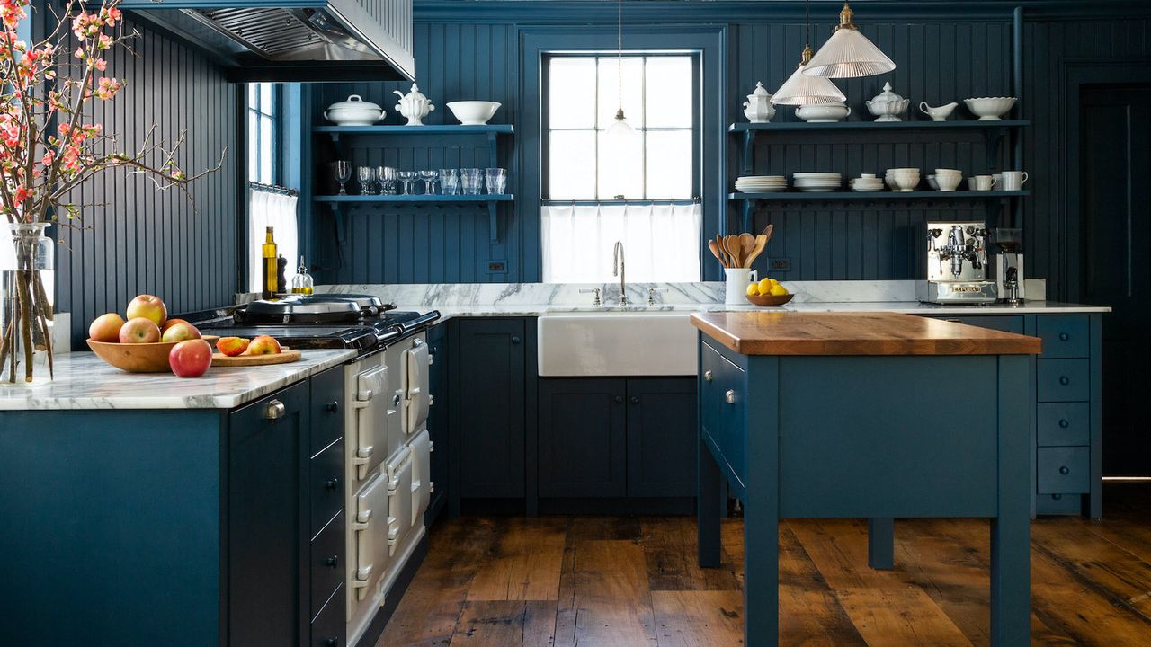 blue shaker kitchen with white Aga and wooden topped island