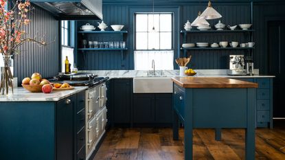 blue shaker kitchen with white Aga and wooden topped island