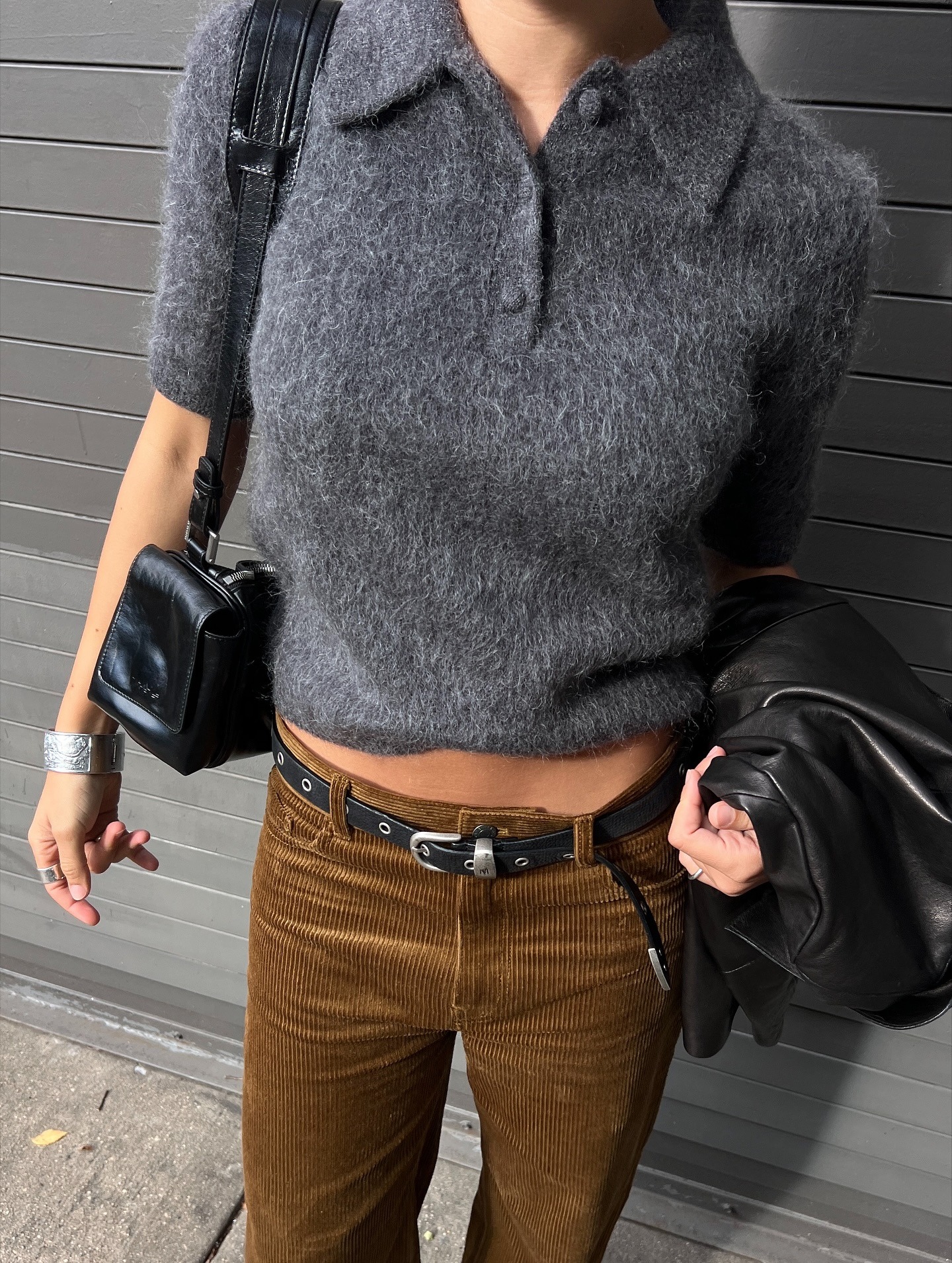 Influencer @aishafarida wears a brushed short sleeve knit with corduroy trousers and a black leather jacket.