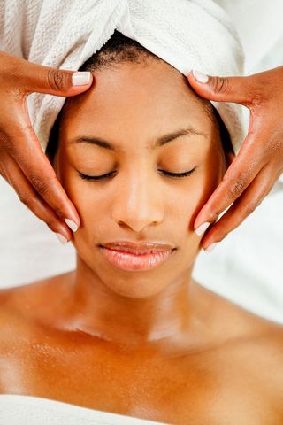 A woman receiving a facial massage