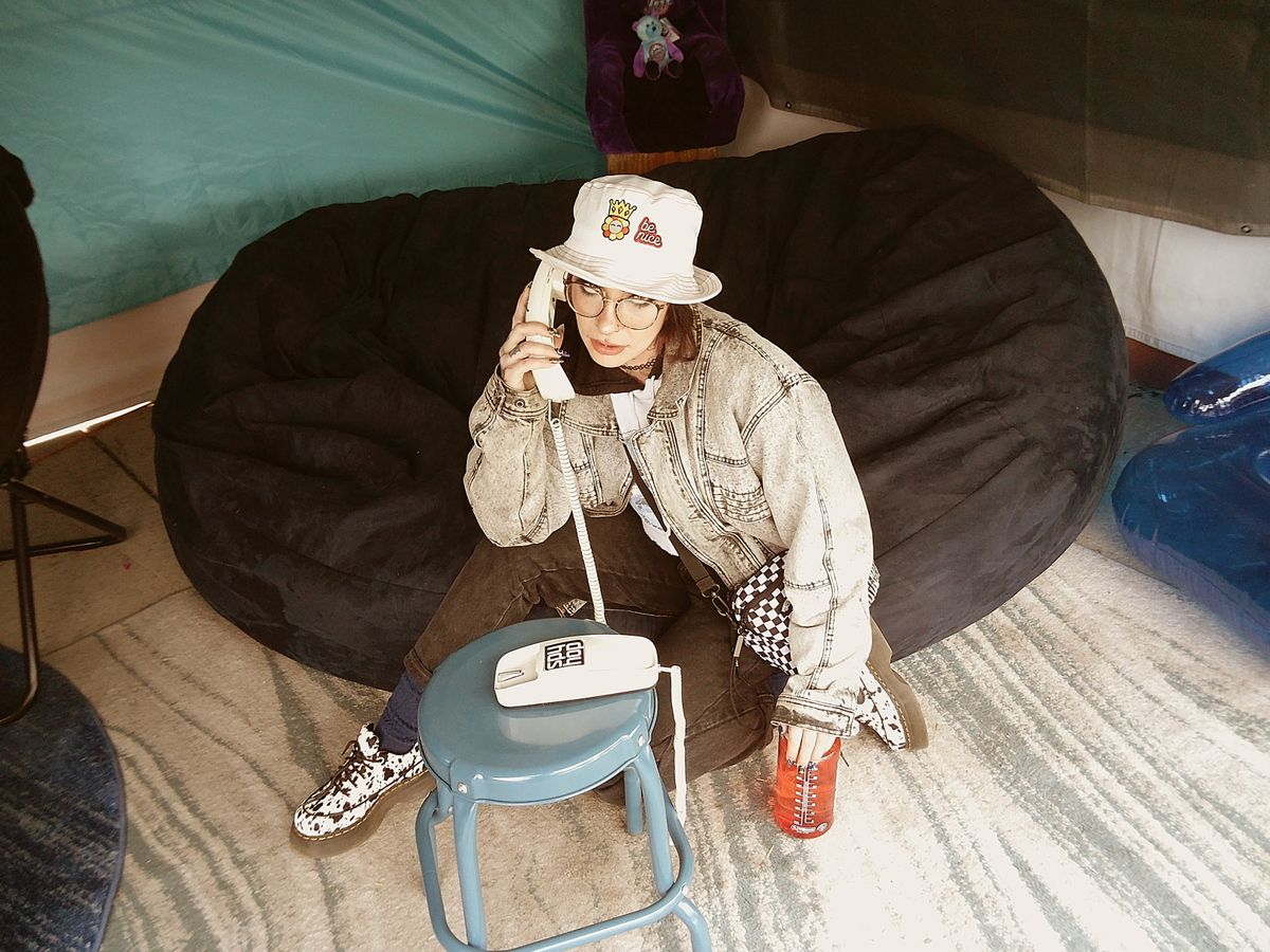 Sample image taken with Camp Snap 2 digital camera showing a young woman posing with a vintage phone