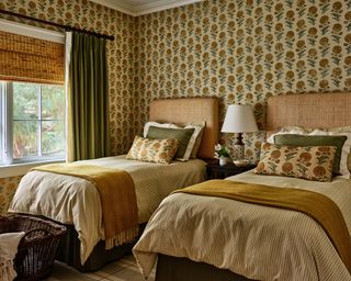 Yellow bedroom with ohcre floral wallpaper and yellow bedlinen