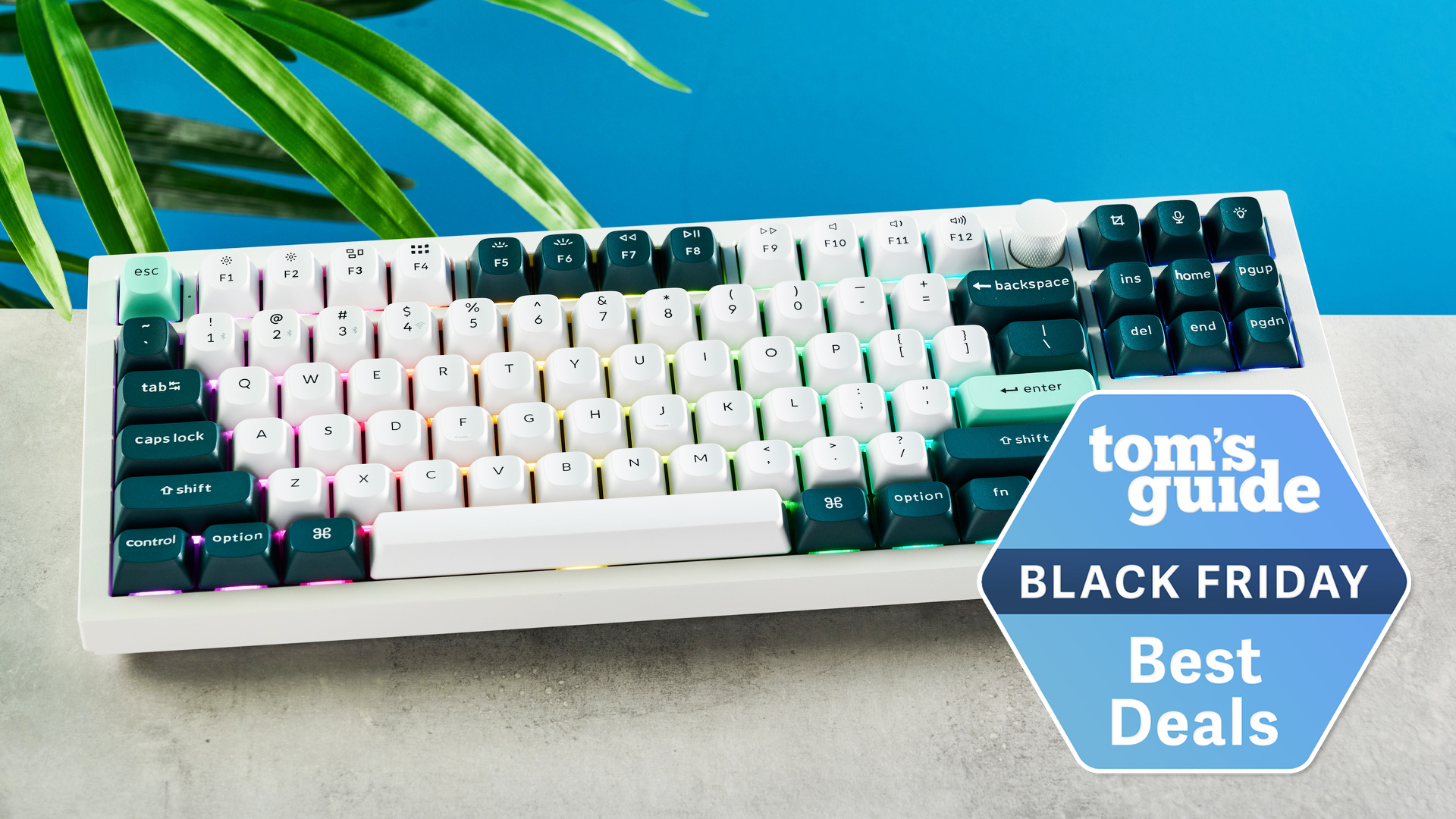 Keychron Q3 HE on a stone surface and a blue background, with a Tom's Guide Black Friday deals badge in the lower right corner of the image