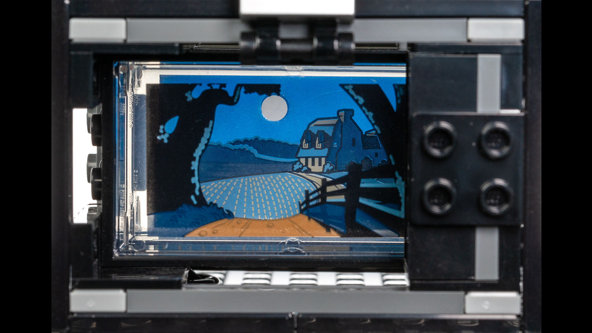Lego Walt Disney Tribute Camera (43230) multi-plane camera side build, close up of the multi-plane frames showing a farm house under moon light