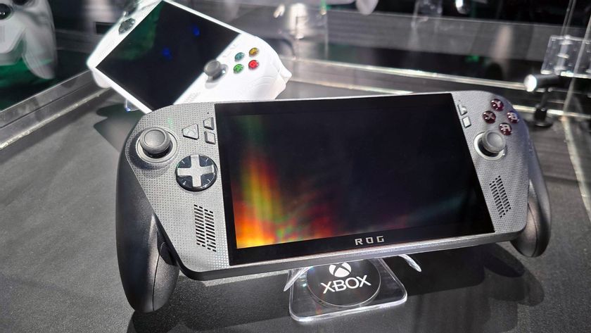 ASUS ROG Xbox Ally X (black) and ROG Xbox Ally (white) in a glass display case at Gamescom in August, 2025.