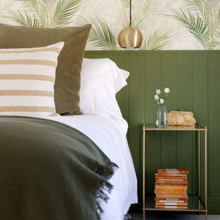 bedroom with a green wall panelling with green wallpaper