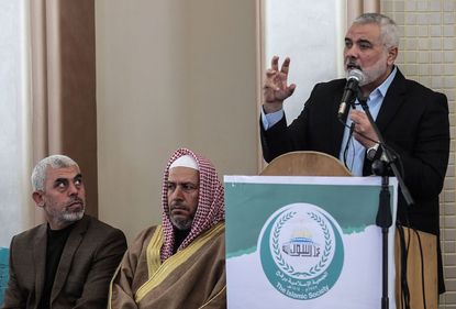 Yahya Sinwar (L) the new leader of Hamas in the Gaza Strip and senior political leaders of the Islamist movement Khalil al-Haya (C) Ismail Haniyeh (R) 