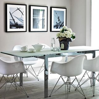 dining room with black and white pictures on wall