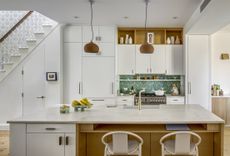 white kitchen with white flush cupboards and island