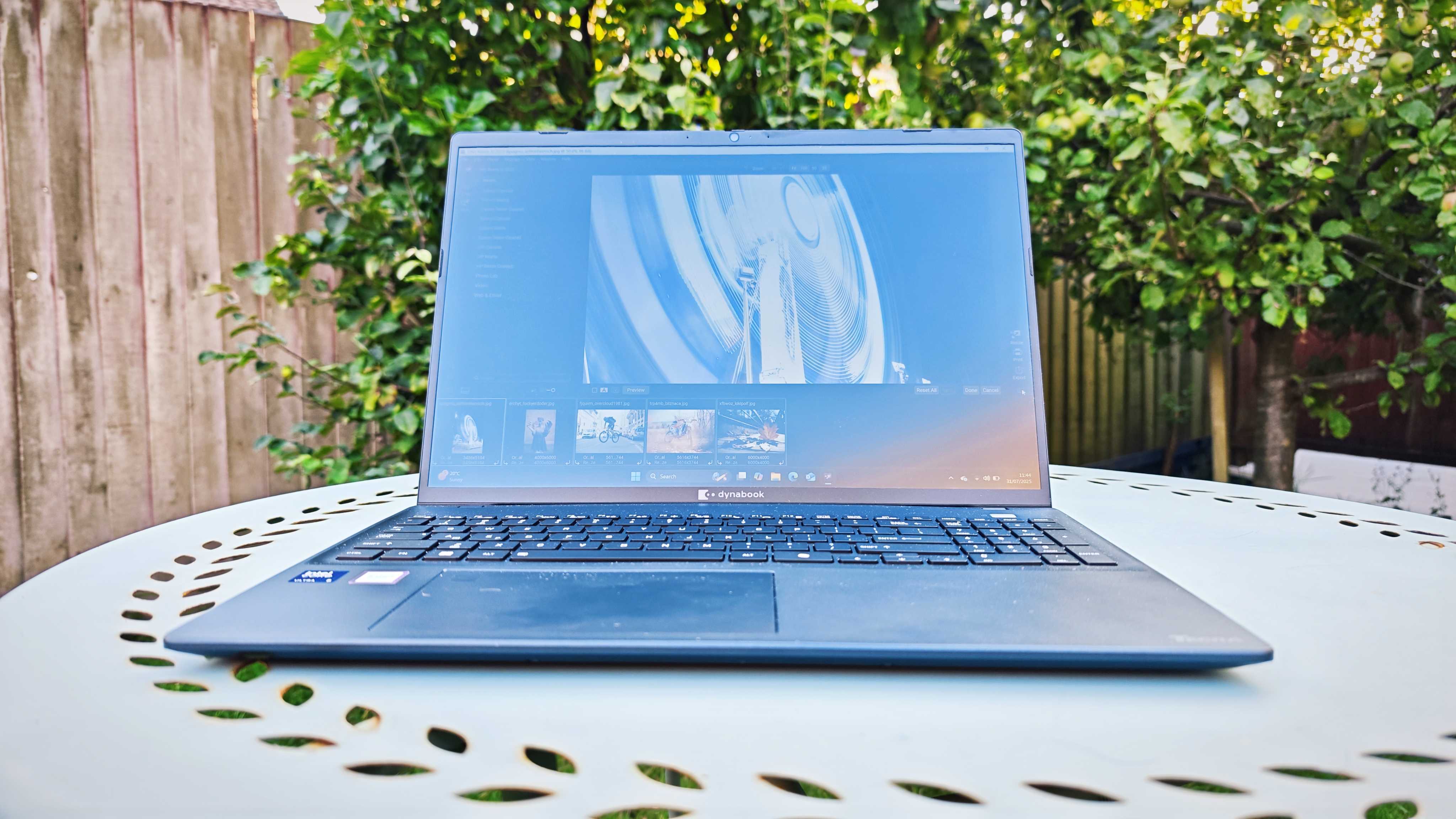 A dark blue Dynabook Tecra A60-M laptop on a garden table