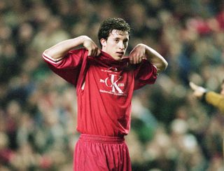 Robbie Fowler of Liverpool celebrates a goal by lifting his shirt to reveal a vest bearing a message of support for the dock workers sacked amid the Liverpool dockers' dispute, 1997