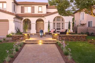 Paved front yard space with low level lighting