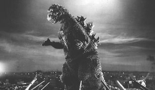 Godzilla rampaging over a small city