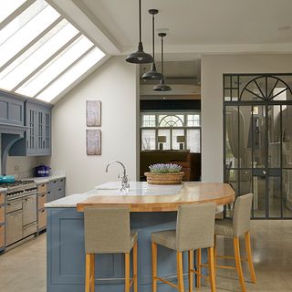 kitchen with glass roof and counter table with dining