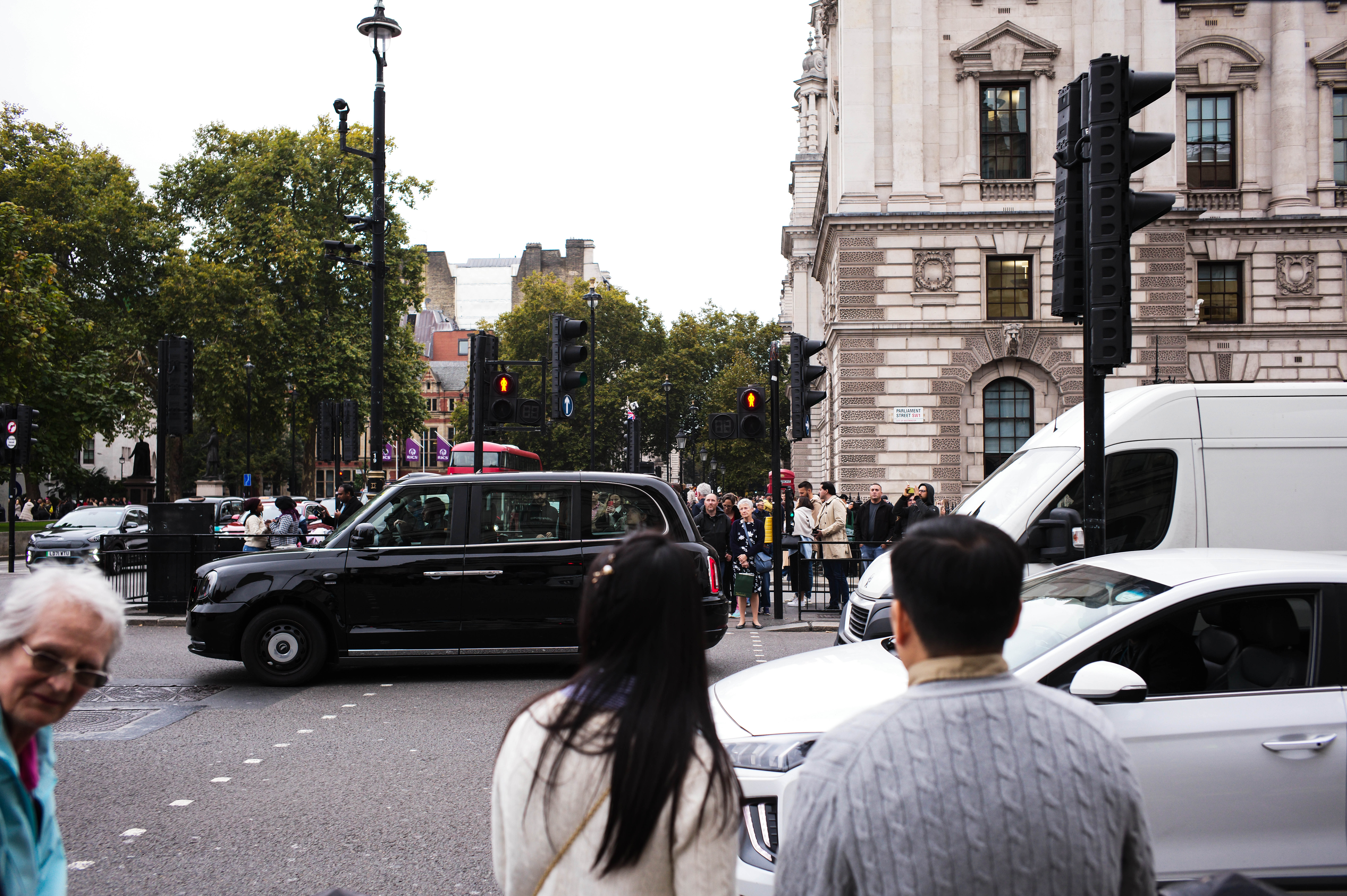 People waiting to cross the street in London