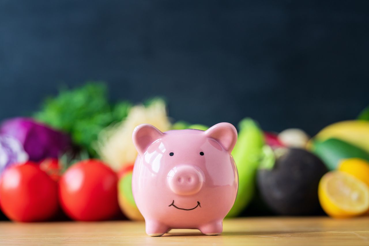 A piggy bank and vegetables