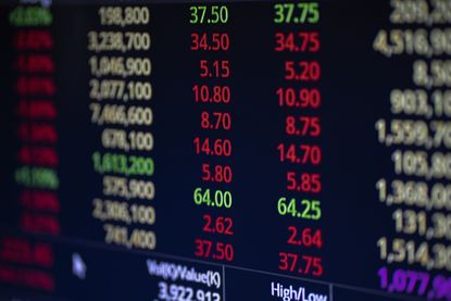 stock market ticker board with red, green and white numbers