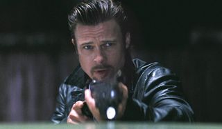Brad Pitt aims his shotgun at the camera in Killing Them Softly.