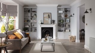 grey living room with fitted shelves and white fireaplace