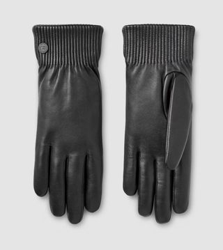 Canada Goose leather gloves in front of a plain backdrop