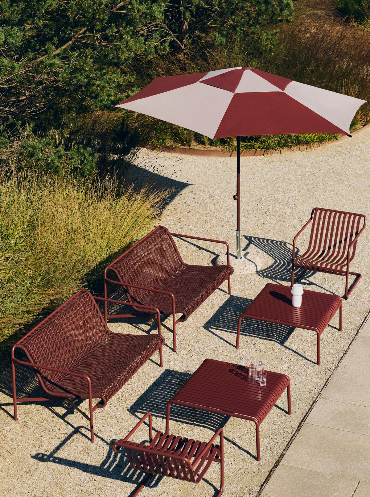 HAY Palissade Cord woven outdoor furniture in iron red with matching parasol