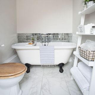 bathroom with white bath tub and white wall