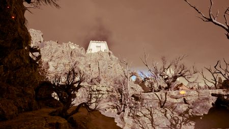 Avowed The Blade that Hungers treasure map location - A scenic shot of a ruin on a rocky hill in the distance, with barren trees in the plateau below.