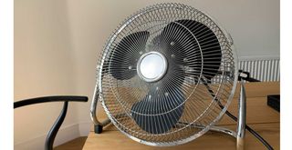 A fan on a table to show how repositioning a fan a worthwhile fan hack to try for cooler air
