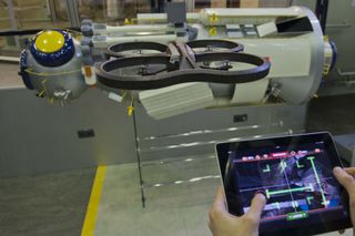 A free ESA app turns a popular iPhone-controlled ‘home drone’ into a spacecraft. The augmented reality game lets owners of Parrot AR.Drone quadcopters attempt dockings with a simulated International Space Station while flying their drones for real – in the process helping to improve robotic rendezvous methods. This new AstroDrone app is part of a scientific crowdsourcing project by ESA’s Advanced Concepts Team, gathering data to teach robots to navigate their environments.