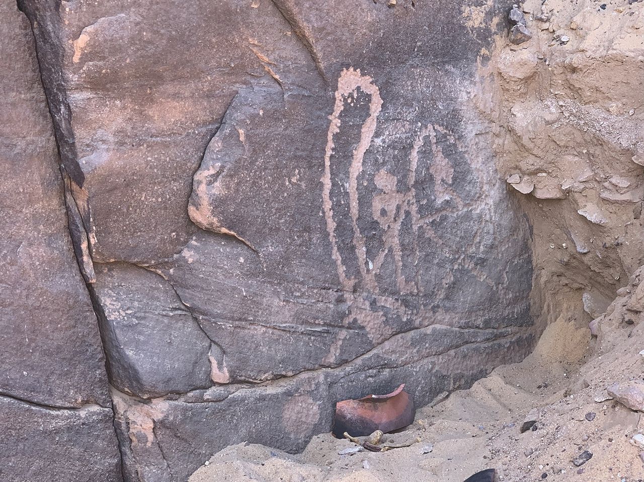a close-up of a rock carving of people rowing a boat