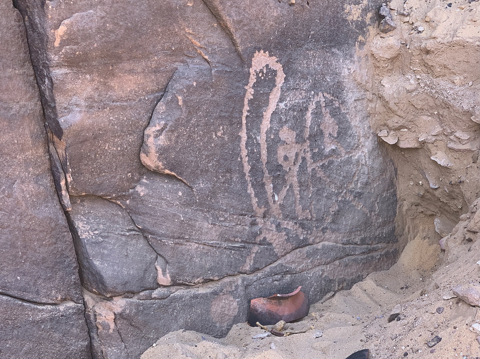 a close-up of a rock carving of people rowing a boat