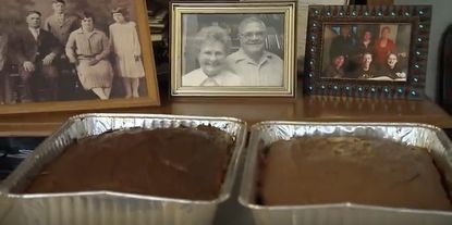A photo of Leo Kellner and his late wife Madeline behind two cakes.